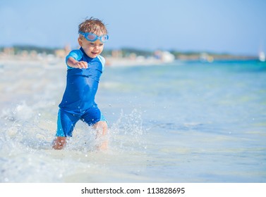 A cute little boy having fun on the exotic beach - Powered by Shutterstock