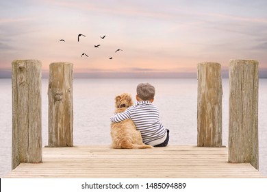 cute little boy with his dog at the sunset jetty on the beach