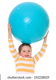 Cute little boy holding head over to the big blue ball, isolated on white background