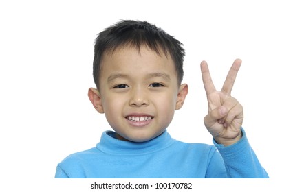 Cute Little Boy Holding Up The Peace Sign, Wearing Blue T-shirt Blue On A White Background