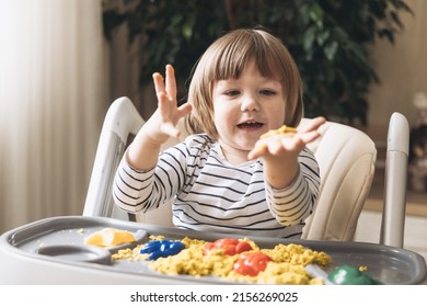 Cute little boy playing with kinetic sand. Development of fine motor skills. Early sensory education. Activities Montessori. Sensory plays at home. - Shutterstock ID 2156269025
