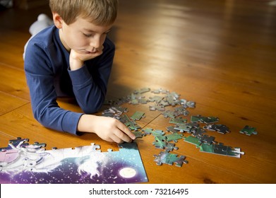 Cute little boy playing with puzzle