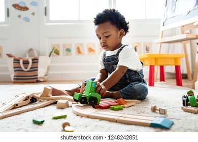 Cute Little Boy Playing With A Railroad Train Toy