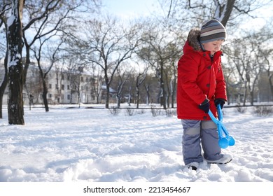 Cute Little Boy Playing With Snowball Maker In Park On Sunny Winter Day. Space For Text