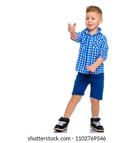 A cute little boy points a finger at something. The concept of advertising, happy childhood. Isolated on white background.