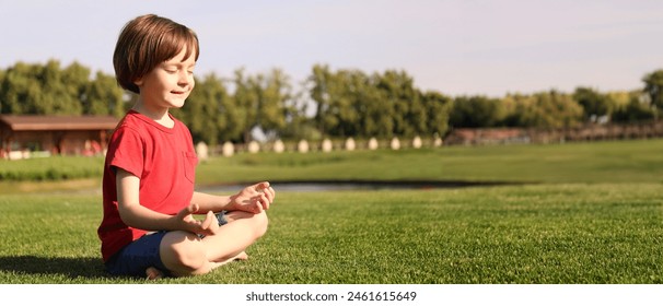 Cute little boy practicing yoga in park on sunny day - Powered by Shutterstock