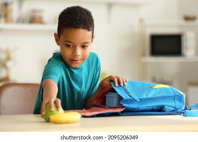 Cute Little Boy Putting His School Lunch In Bag