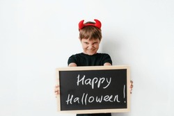  Cute Little Boy With Red Devil Horns And Black Board With Happy Halloween Text Isolated On White Background