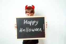  Cute Little Boy With Red Devil Horns And Black Board With Happy Halloween Text Isolated On White Background