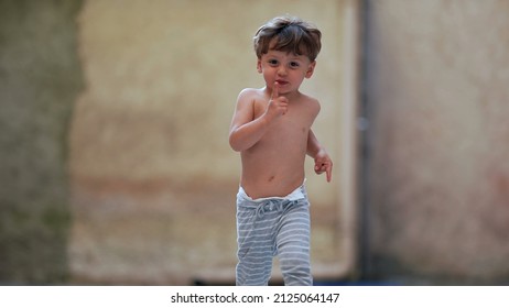 Cute Little Boy Running Outside Towards Camera