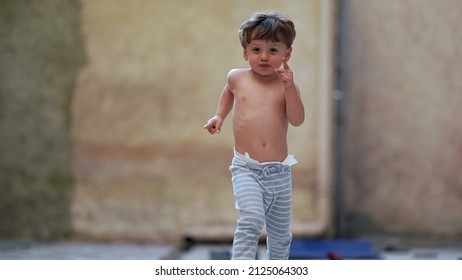 Cute Little Boy Running Outside Towards Camera