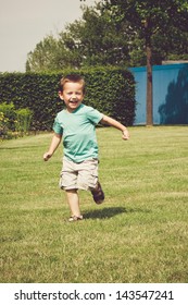 Cute Little Boy Running In The Park