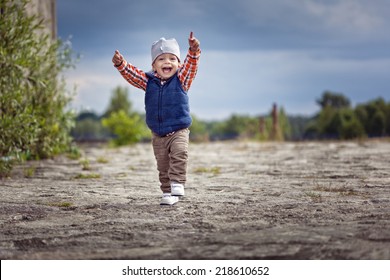 Cute Little Boy Running And Smiling With Hands Up