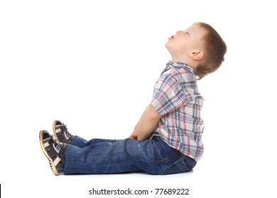 Cute Little Boy Sitting Look Up To Empty Copy Space Isolated On White Background. Concept.