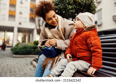 A Cute Little Boy Sitting Outside With A Young Woman, Nanny Or Caregiver, And Telling Something Important.