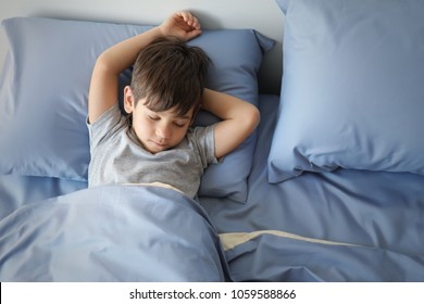 Cute little boy sleeping in bed at home - Powered by Shutterstock