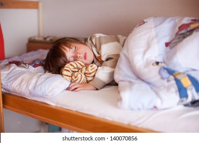 Cute Little Boy Sleeping On Bunk Bed At Hole