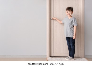 Cute Little Boy Standing Near Closed Door