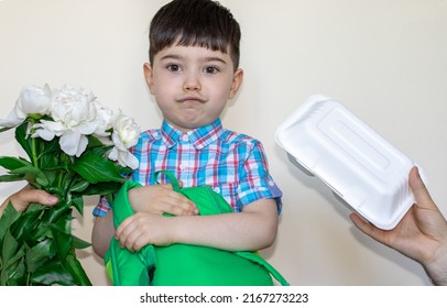 Cute Little Boy Staying In The Middle And Make Funny Face,mouth Expression.mother Hand Gives Flowers,white Peonies, And Father Hand Hold Lunch Box From Another Side. Ready For.back To School