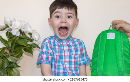 Cute Little Boy Staying In The Middle And Make Funny Face,wow  Expression,wide Open Mouth.mother Hand Gives Flowers,white Peonies, And Father Hand With Green Backpack From Another Side.ready For Back 