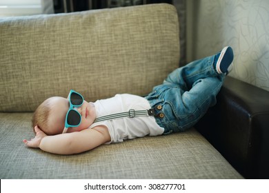 cute little boy in sunglasses at home