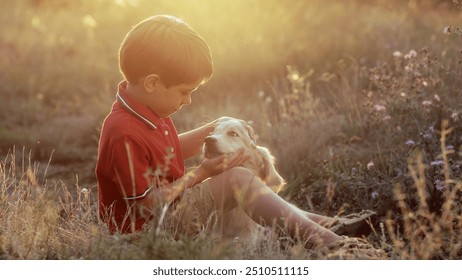 Cute little boy talking with golden retriever puppy on countryside nature background. Golden hour, sunset light. Child stroking dog. Happy lovely pet, new member of family. High quality  - Powered by Shutterstock