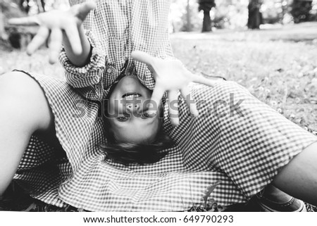 Cute little boy upside down fooling on mothers hands. Black and white photo