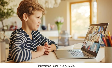 Cute Little Boy Uses Laptop With Conference Video Call Software To Talk With Group Of Relatives And Friends. Happy Family Connected Online