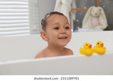 Cute little boy washing hair with shampoo in bathroom - Shutterstock ID 2311289701