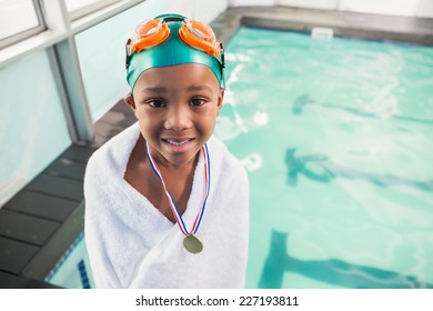 Cute little boy wrapped in towel with medal poolside at the leisure center - Powered by Shutterstock