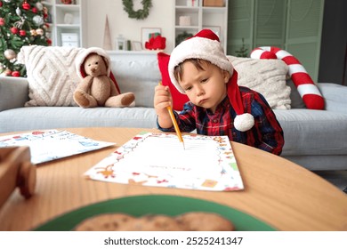 Cute little boy writing letter to Santa at home on Christmas eve - Powered by Shutterstock