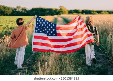 Cute little boys - American patriot kids running with national flag on open area countryside road.USA, 4th of July - Independence day, celebration. US banner,memorial Veterans,election. High quality - Powered by Shutterstock