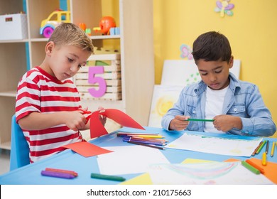 Cute little boys drawing at desk at the nursery school - Shutterstock ID 210175663