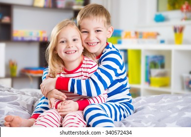 Cute little brother and sister in pajamas at home - Powered by Shutterstock