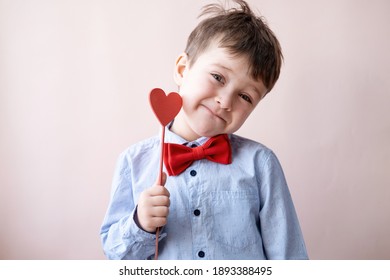 Cute Little Caucasian Boy In Bow Tie With Heart On Stick. Valentine Day.