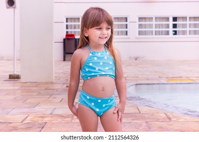 cute little caucasian girl in bikini smiling looking at camera