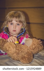 Cute Little Caucasian Girl Playing Doctor With Her Favourite Teddy Bear