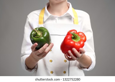 Cute little chef with peppers on grey background, closeup - Shutterstock ID 1322752280
