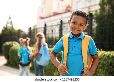 Cute little child with backpack outdoors. Elementary school - Powered by Shutterstock