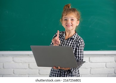 Cute Little Child Girl Using Laptop Computer, Kid Studying Through Online E-learning. Little Funny System Administrator.