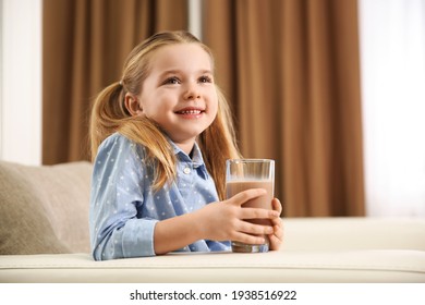 Cute Little Child With Glass Of Tasty Chocolate Milk At Home