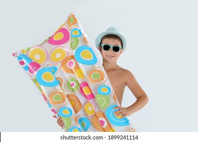 Cute little child with inflatable mattress on white background. Beach holiday
