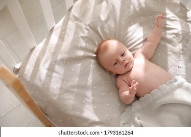 Cute Little Child Lying In Cot, Above View. Healthy Baby