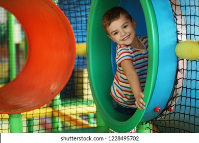 Cute Little Child Playing At Indoor Amusement Park