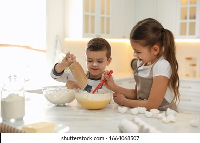 Cute Little Children Cooking Dough Together In Kitchen