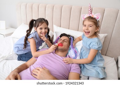 Cute Little Children Painting Face Of Their Father While He Sleeping In Bed At Home