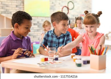 Cute little children painting at table indoors. Learning by playing - Shutterstock ID 1117514216