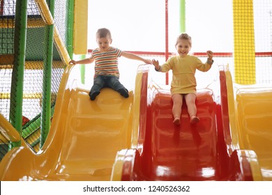 Cute Little Children Playing At Indoor Amusement Park