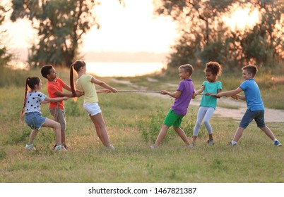 Cute little children playing outdoors at sunset - Powered by Shutterstock