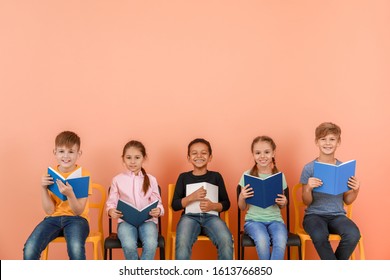 Cute little children reading books on color background - Shutterstock ID 1613766850